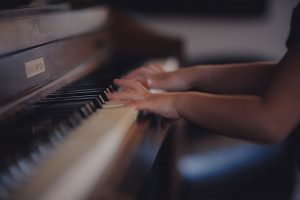 A girl playing piano by herself