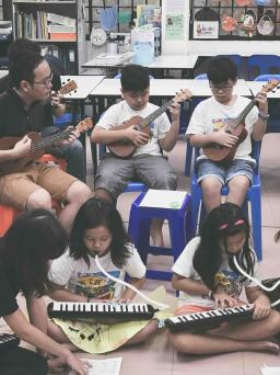 Music school singapore with students and family