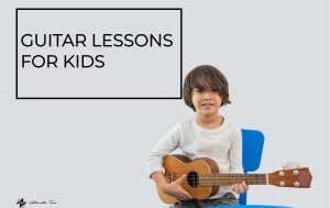 child enjoying his guitar lesson